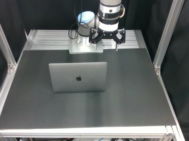Robot closing a laptop in the training setup